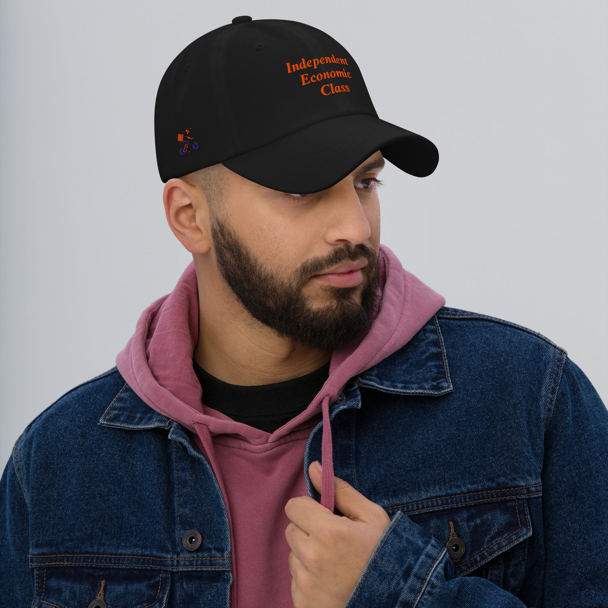 Man wearing a navy cap with text, The Gig Economy Playbook Bike Rider on the Right Side and Independent Economic Class on the front.