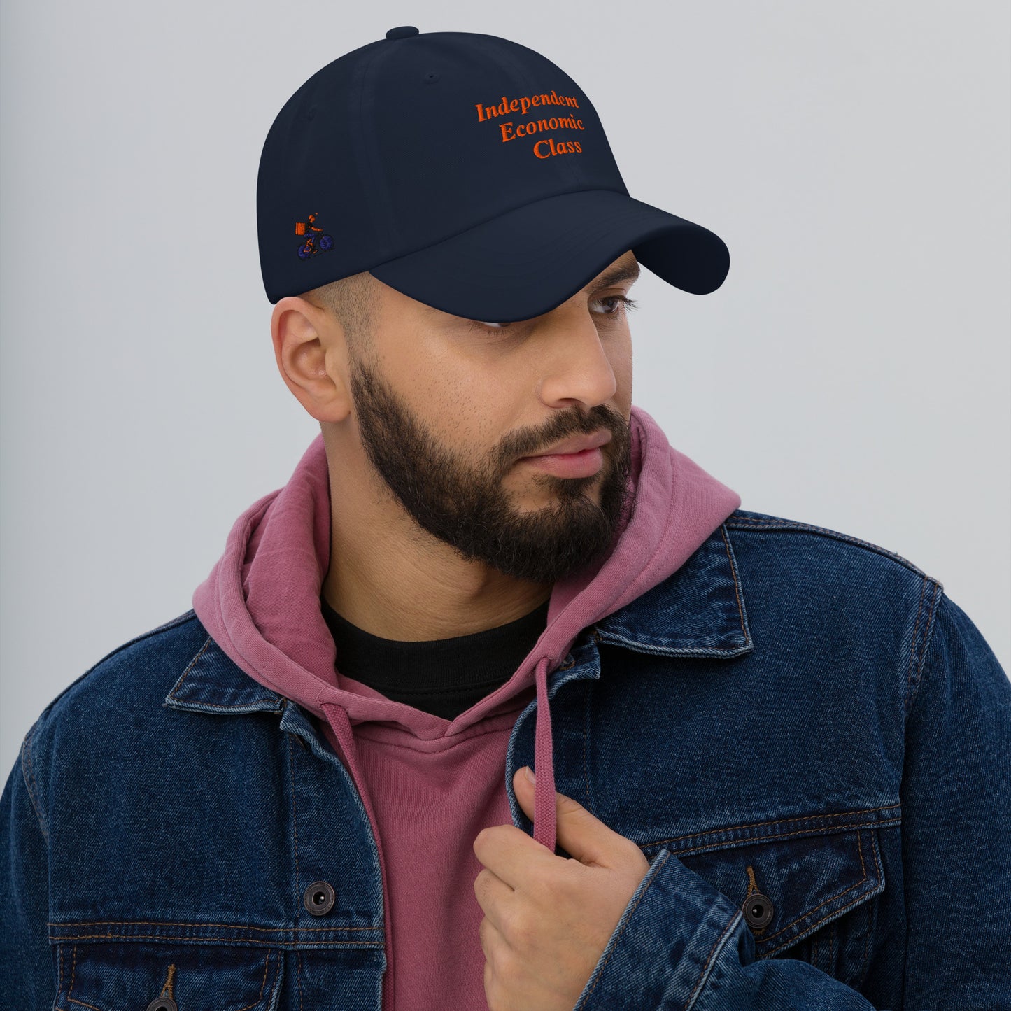 Man wearing a navy cap with text, The Gig Economy Playbook Bike Rider on the Right Side and Independent Economic Class on the front.