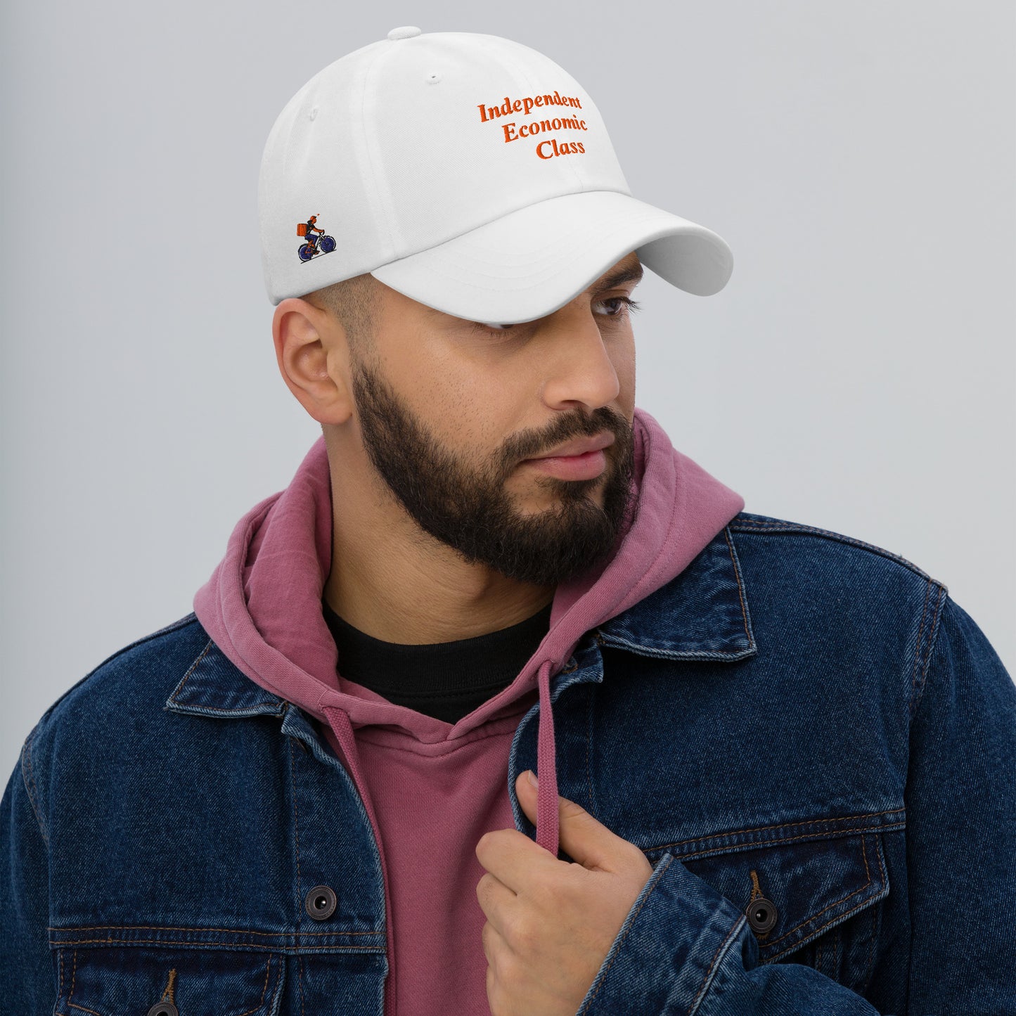 Man wearing a white cap with text, The Gig Economy Playbook Bike Rider on the Right Side and Independent Economic Class on the front.